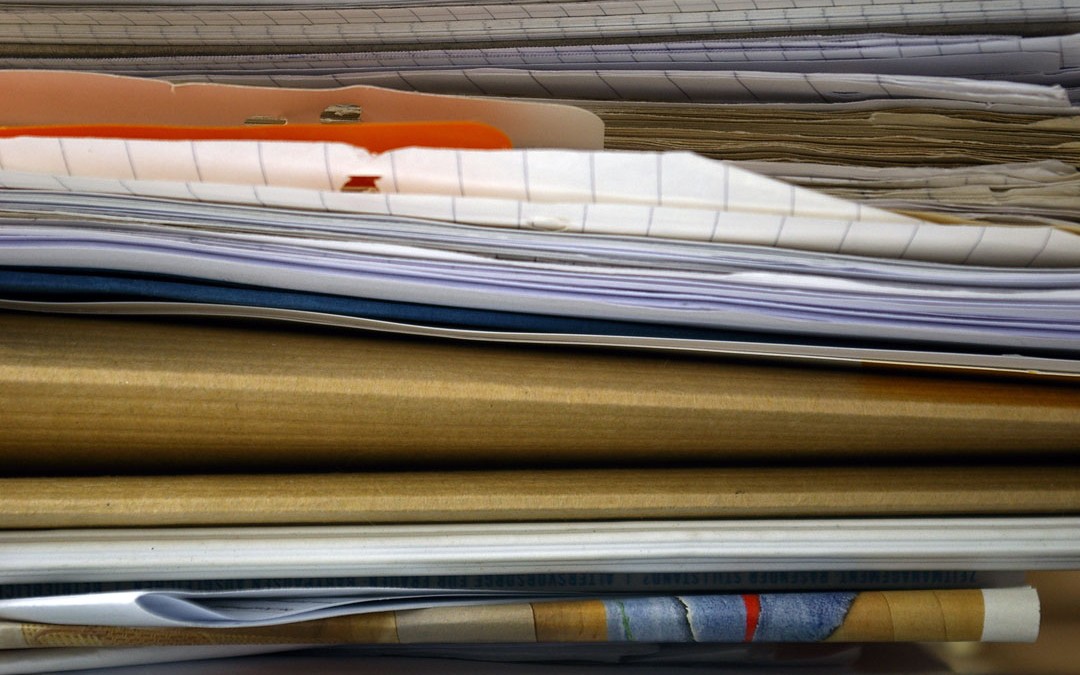 A close-up shot of a messy stack of papers.
