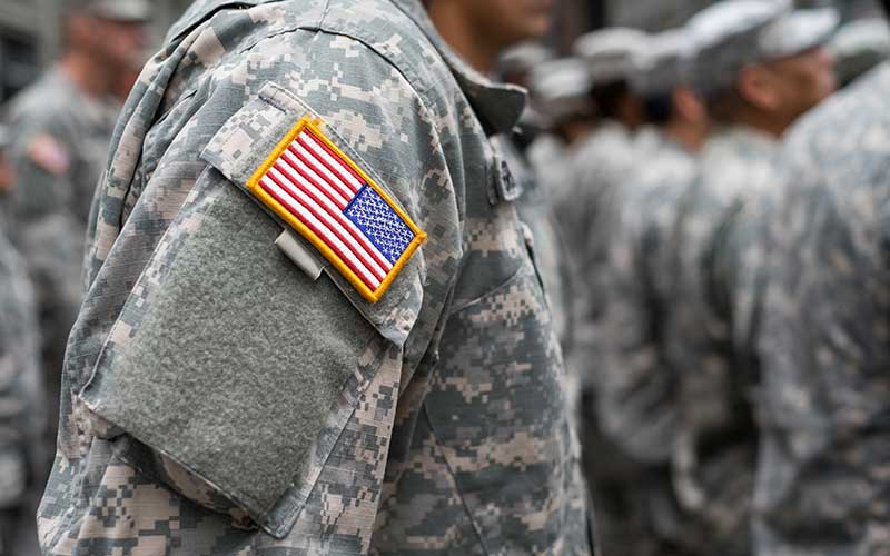 A closeup view of an American Flag patch on a US soldier's uniform.